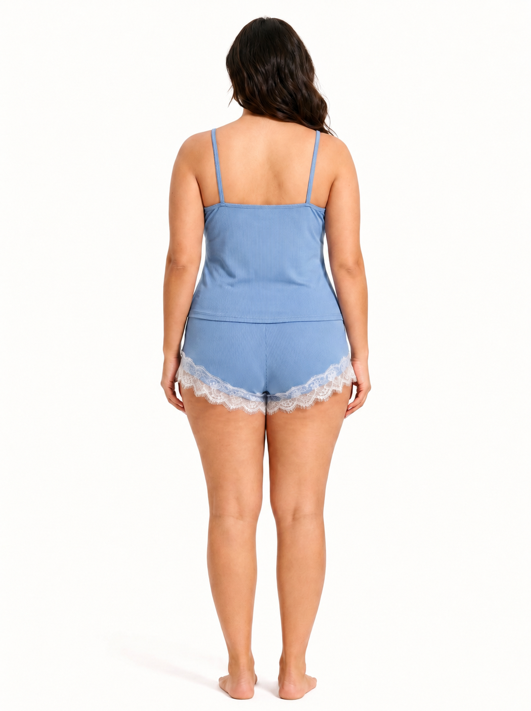 Woman wearing blue ribbed knit pajama shorts with white lace trim and a grey drawstring.