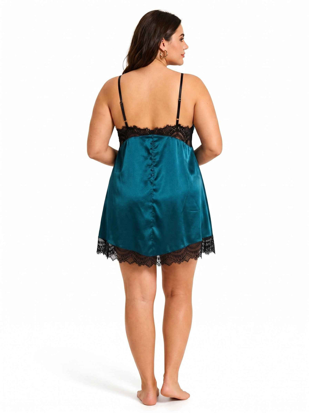 Rear view of a woman wearing a teal satin slip dress with black lace detailing on the bust and hem.