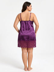 Back view of a woman in a purple satin chemise with lace hem