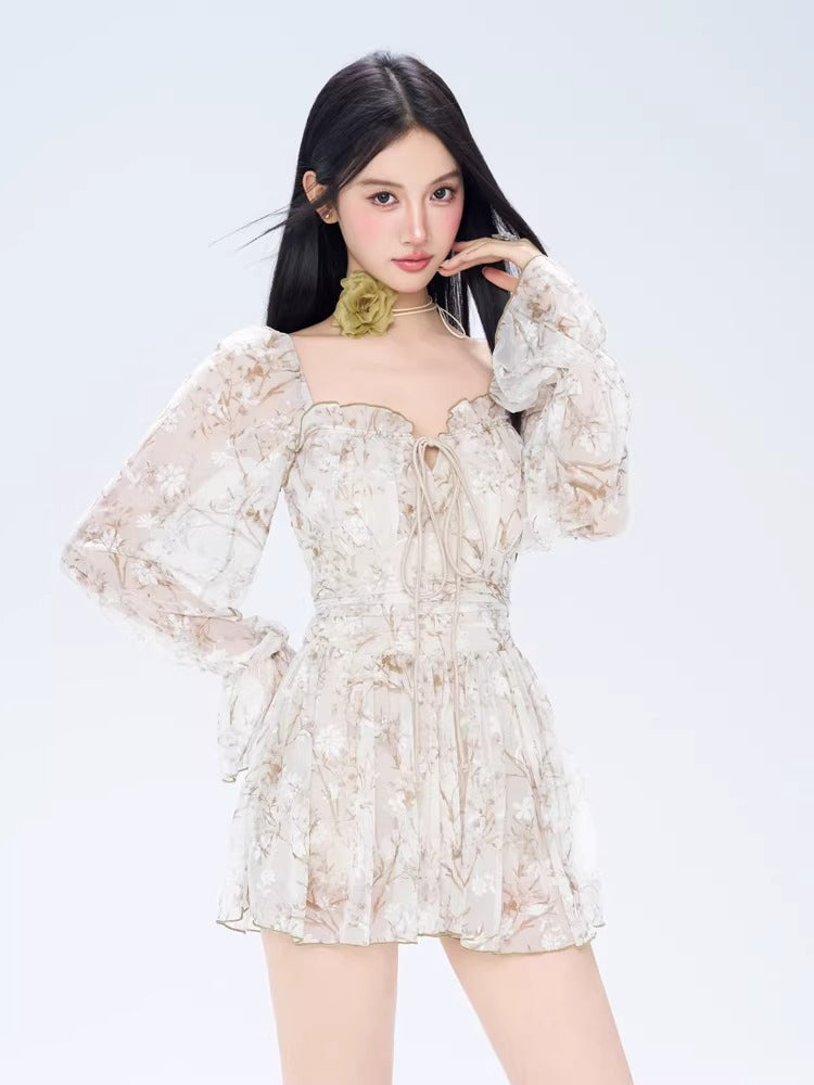 Front view of a woman posing in a floral print off-the-shoulder dress with a green floral choker.