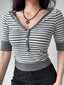 Detail shot of the neckline and buttons on a grey and white striped cropped top.