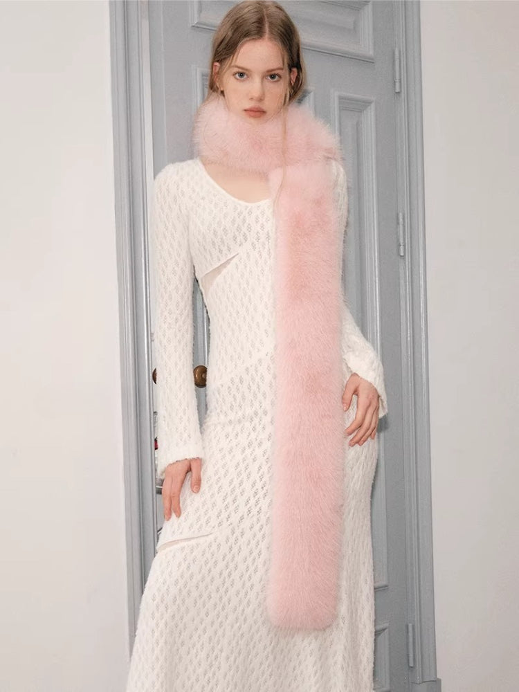 woman wearing a white knit dress and a pink faux fur scarf