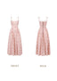 Front view of a pink floral print midi dress with a square neckline and tie straps