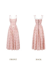 Front view of a pink floral print midi dress with a square neckline and tie straps