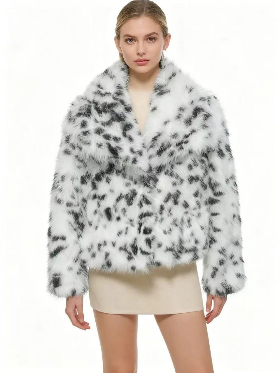 front view of a woman in a dalmatian print faux fur cropped jacket with arms crossed