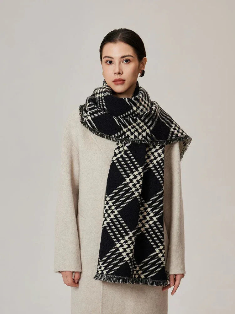 Woman in a cream coat and a black and white tartan scarf