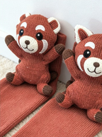 Pair of red panda character crew socks laid out
