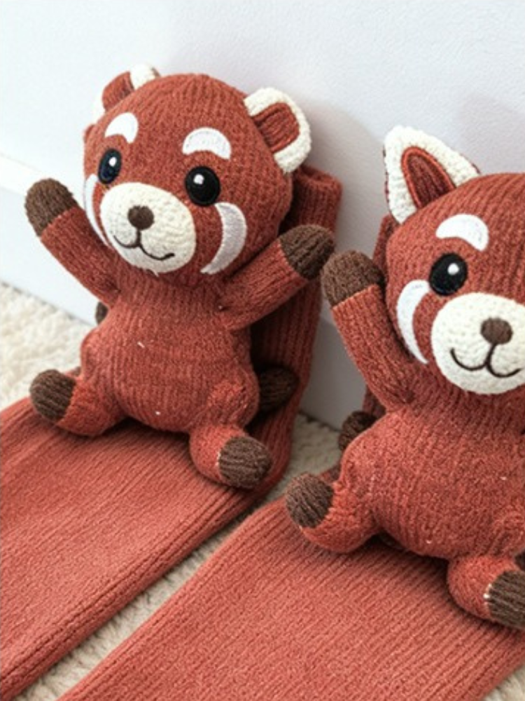 Pair of red panda character crew socks laid out