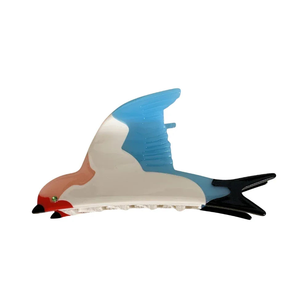 A single bird-shaped hair clip with blue, white, and pink coloring, against a white background.
