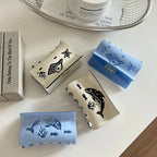 A group of four decorative hair claw clips featuring ocean life designs