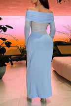Back view of a woman wearing a light blue off-the-shoulder gown with sheer mesh panels and draped detailing.