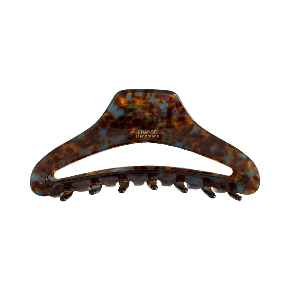 A single tortoiseshell claw hair clip on a white background. Main image