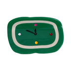 Green clock-shaped hair clip with colorful dots