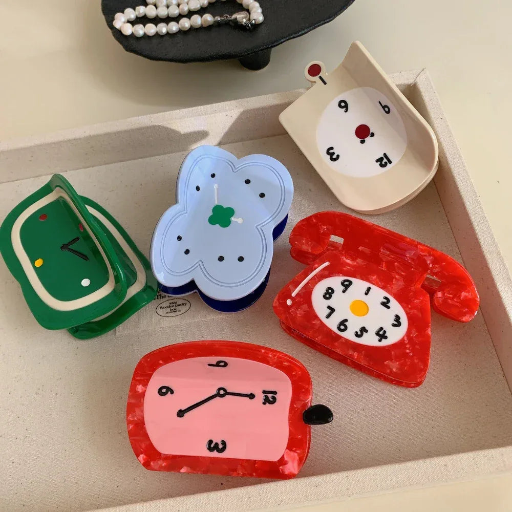 Assortment of novelty hair clips including clocks and a telephone