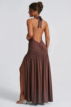 back view of a woman wearing a brown halter maxi dress with an open back and ruched detailing