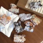 Collection of dog-shaped hair clips on a pillow and table