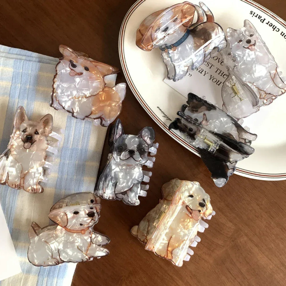 Various dog breed hair clips on a plate and table