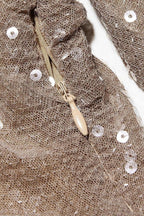 Detail shot of the zipper and sequin texture on a dress.