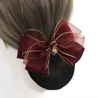 burgundy hair bun cover with a burgundy sheer organza bow with gold trim and charm