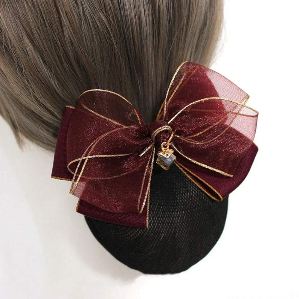 burgundy hair bun cover with a burgundy sheer organza bow with gold trim and charm