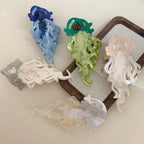 Collection of five jellyfish hair clips in various colors: blue, green, pink, white, and clear