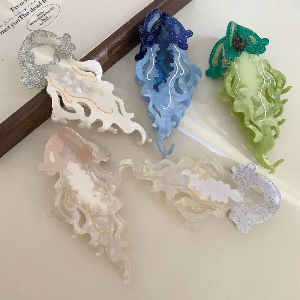 Top-down view of five jellyfish hair clips scattered on a surface