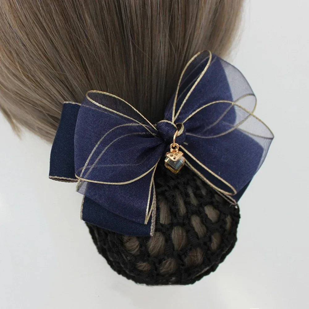 navy blue hair bun cover with a navy sheer organza bow with gold trim and charm