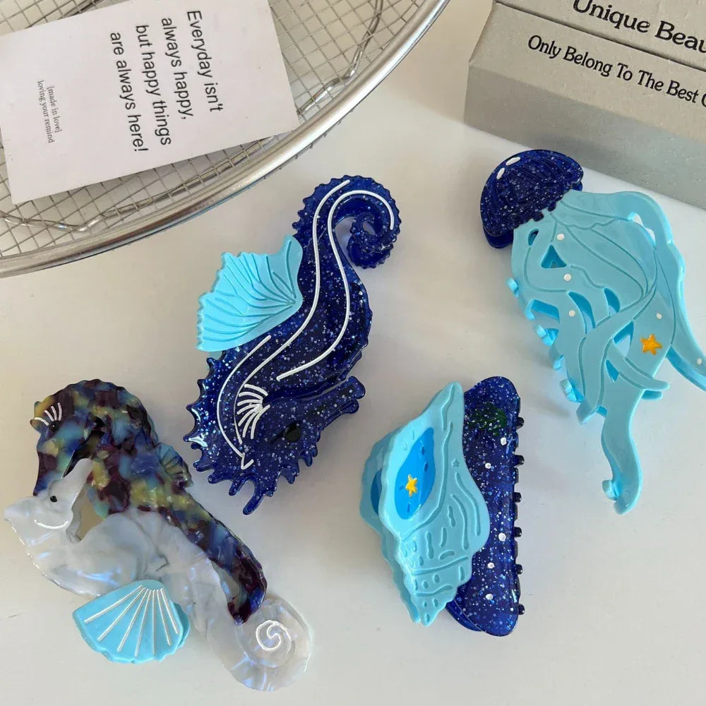 Collection of ocean-themed hair clips including seahorses, a jellyfish, and a seashell