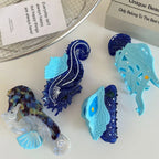 Collection of ocean-themed hair clips including seahorses, a jellyfish, and a seashell