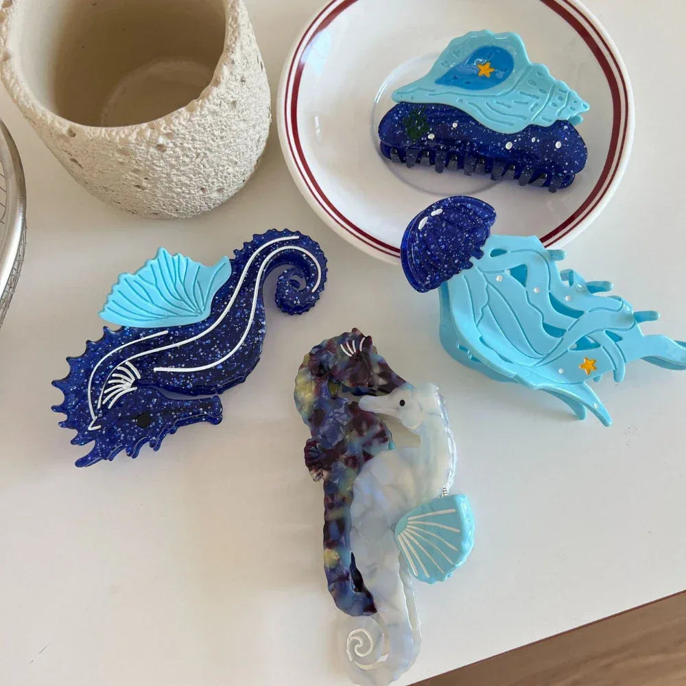 Assortment of blue and dark blue hair clips with marine life designs