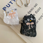 White and black marbled cat hair clips with pink bows and text background