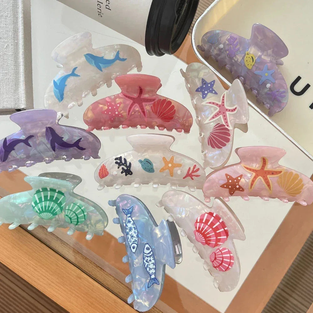 Collection of ocean-themed claw clips in various colors and designs