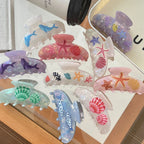 Collection of ocean-themed claw clips in various colors and designs