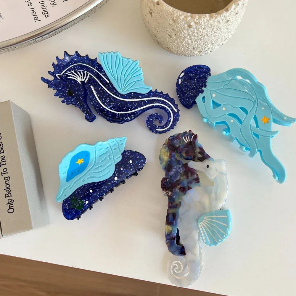 Various hair accessories with nautical motifs, such as seahorses and seashells