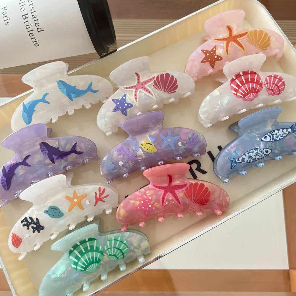 Assortment of iridescent hair claw clips featuring sea life motifs