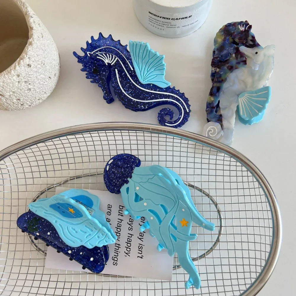 Close-up of a blue seashell hair clip with glitter details