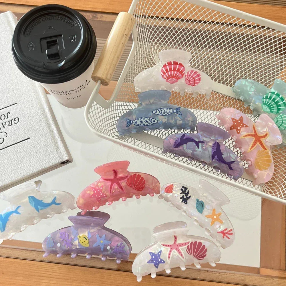 A basket filled with iridescent hair claw clips showcasing marine life patterns