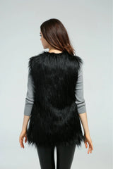 Back view of a woman in a black faux fur vest