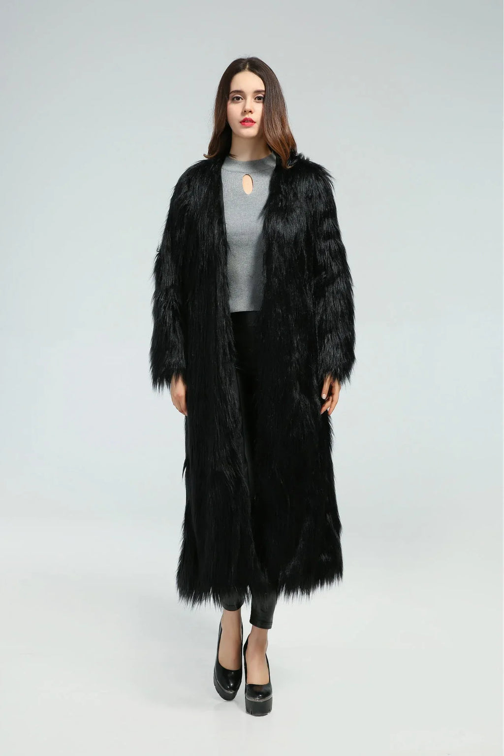 Front view of a woman in a long black faux fur coat