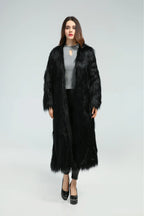 Front view of a woman in a long black faux fur coat
