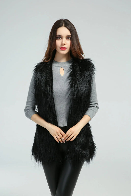 Front view of a woman in a black faux fur vest and grey top