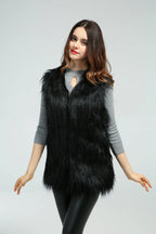 Woman posing with arms outstretched wearing a black faux fur vest