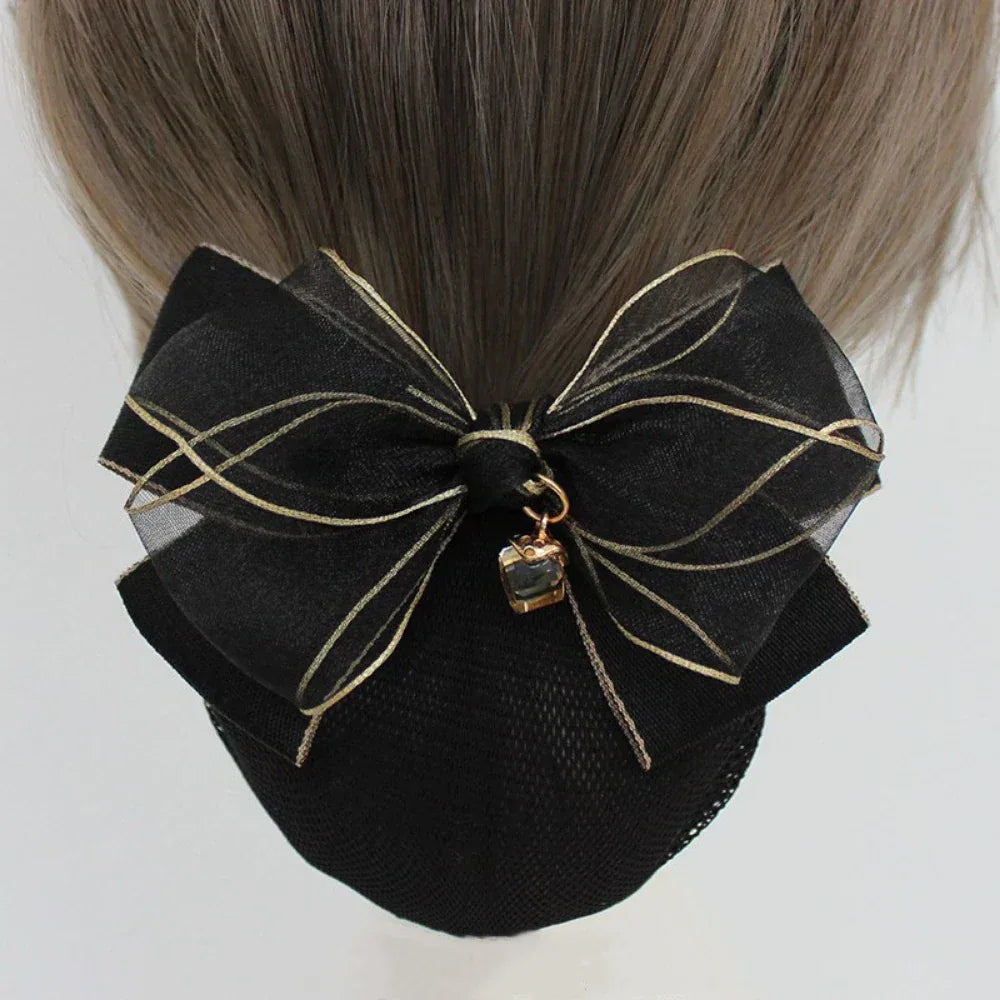 back view of a black hair bun cover with a black sheer organza bow with gold trim and charm