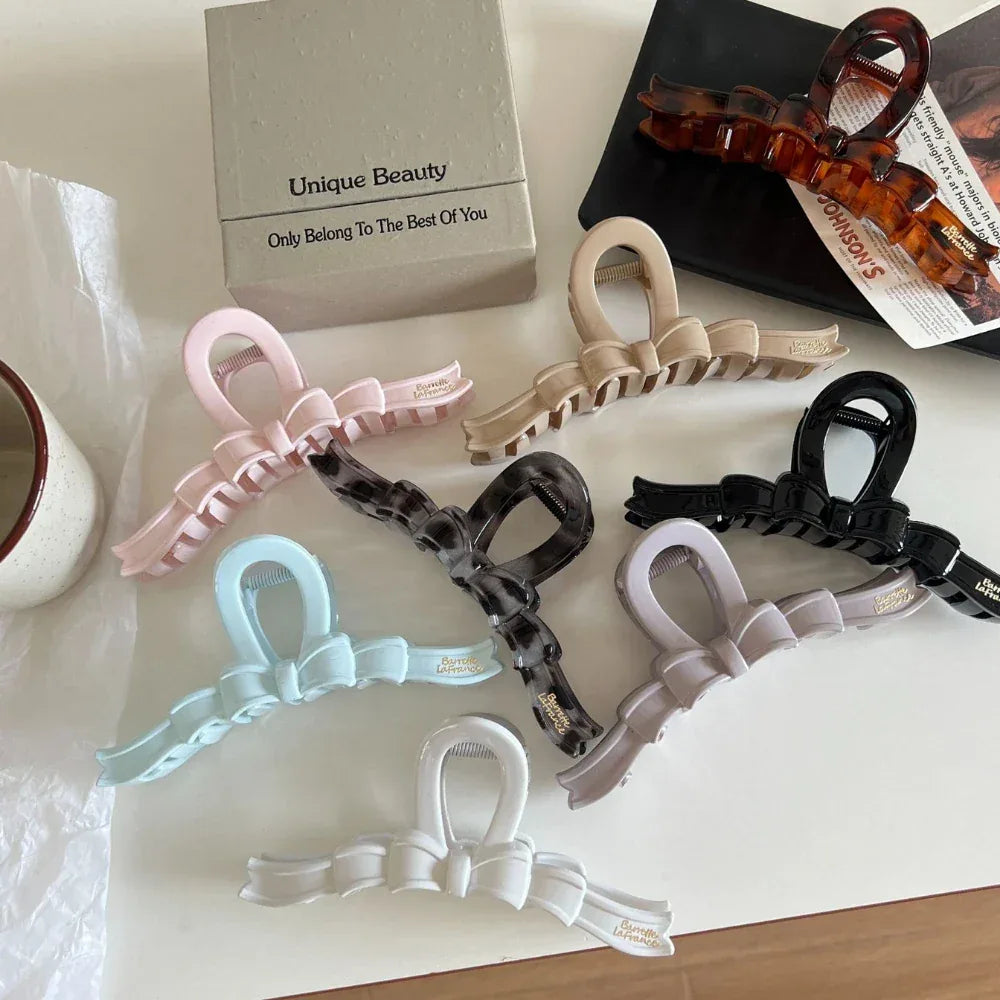 A flat lay arrangement of bow claw clips in multiple colors.