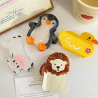 collection of animal hair claw clips including a cat, lion, penguin, and duck on a white surface