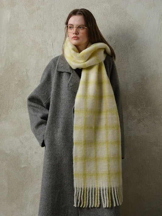 woman wearing a grey coat and a yellow plaid scarf