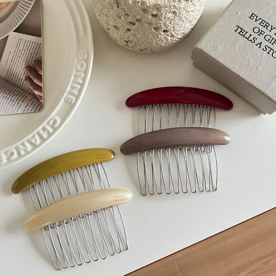 Four hair combs in different colors (maroon, taupe, olive green, and cream) arranged on a white surface. Secondary image