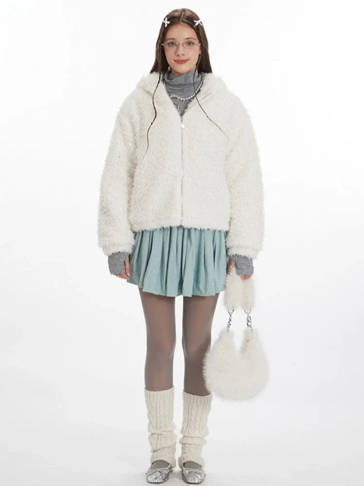 Model wearing a white fuzzy hooded jacket with bunny ears, a grey turtleneck, a light blue pleated skirt, grey tights, and white leg warmers. She is holding a white fuzzy purse. Main image