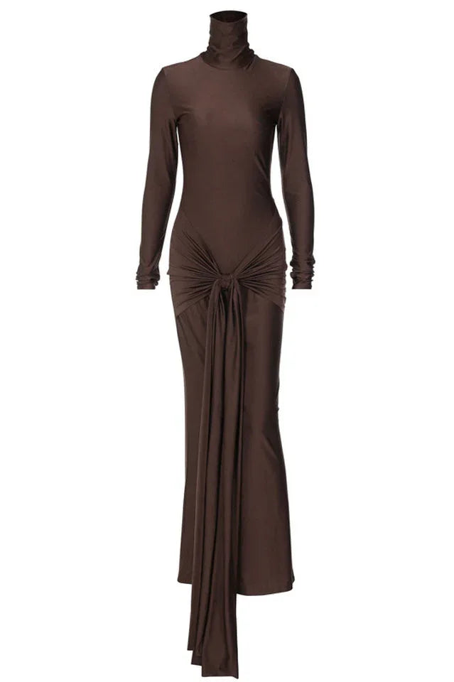 A long-sleeved, brown, mock neck, floor-length dress with a draped knot detail at the waist, displayed on a white background.