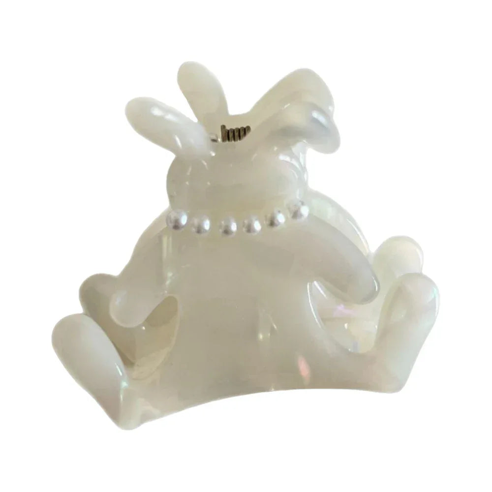 A white bunny-shaped hair claw clip with a pearl-beaded collar, isolated on a white background. Main image